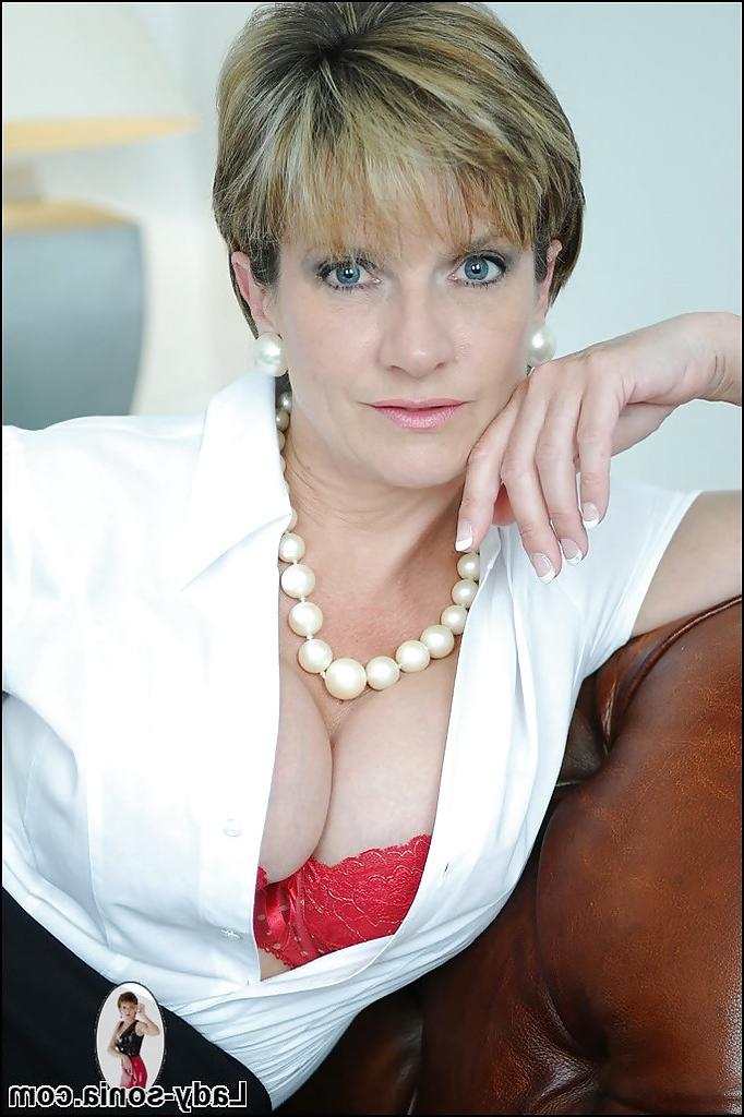 15P Lady Sonia is posing on the sofa and showing her sexy boobies