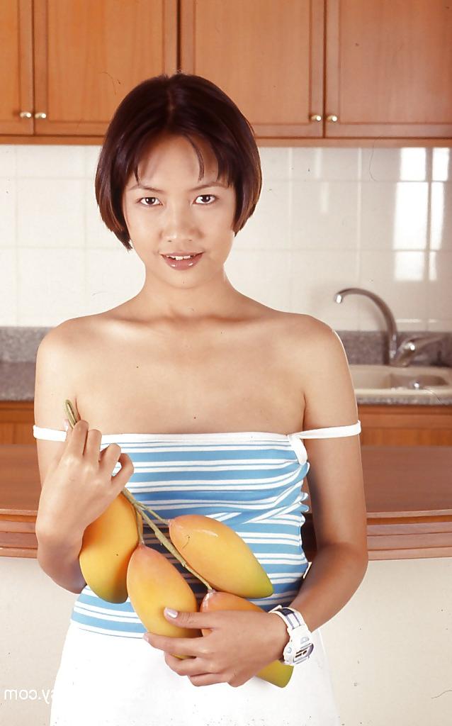 16P Clothed Asian with tiny tits is posing in the kitchen with spread legs