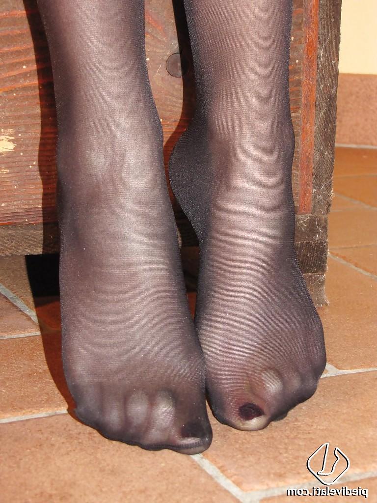 16P Beautiful brunette girl Lolo demonstrating her cute feet in pantyhose