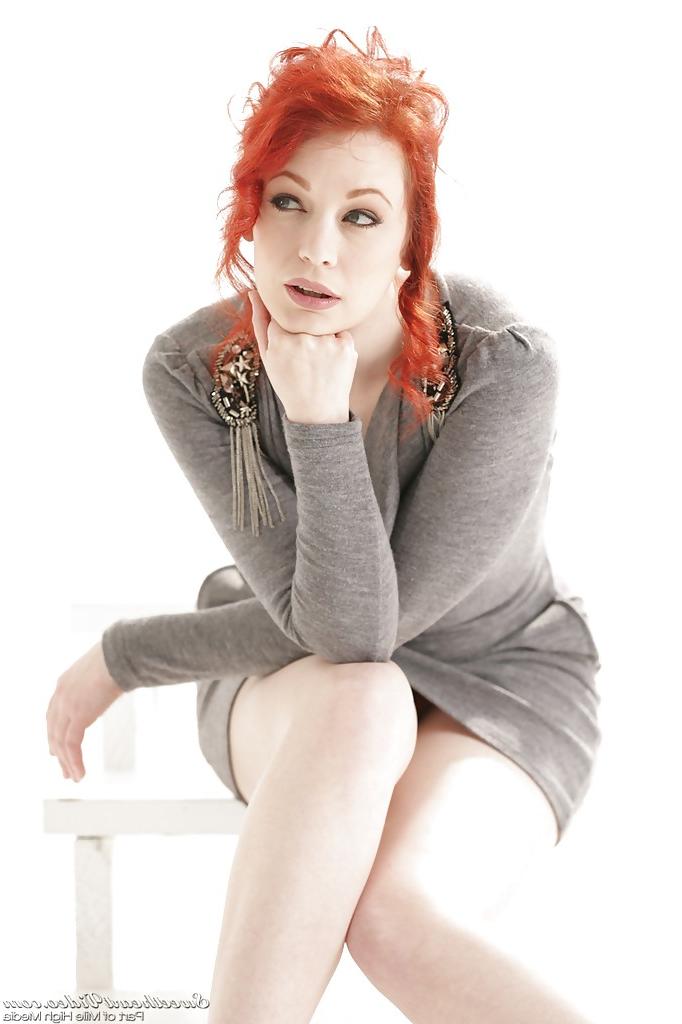 16P Clothed redhead Justine Jolie reveals her milf ass in a skirt