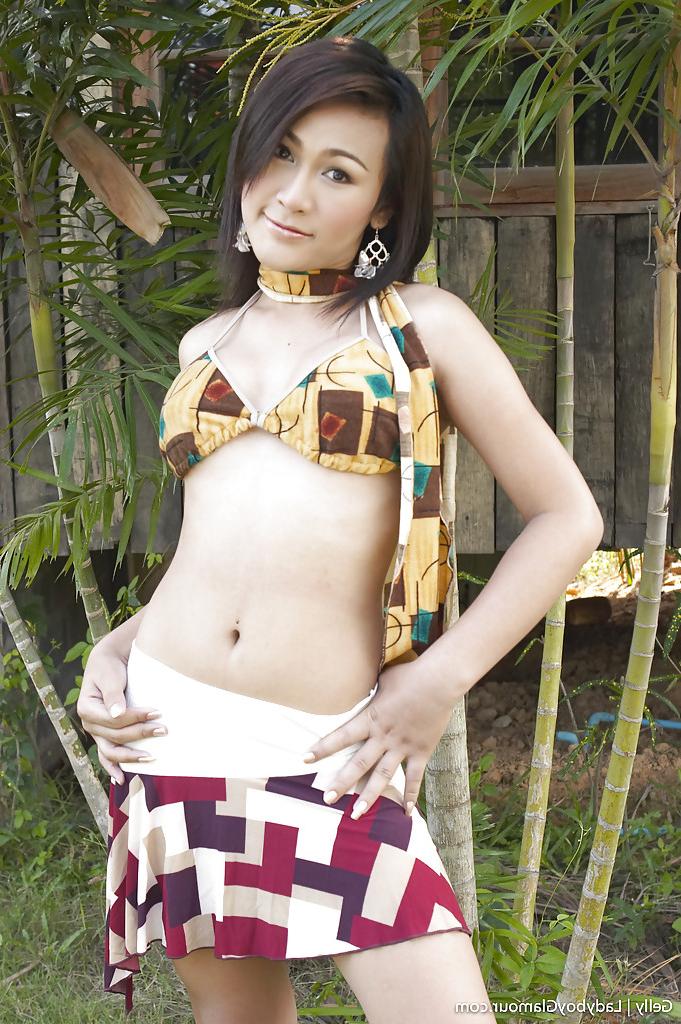 16P Gorgeous Thai ladyboy Gelly and her uncut shecock posing solo outdoors