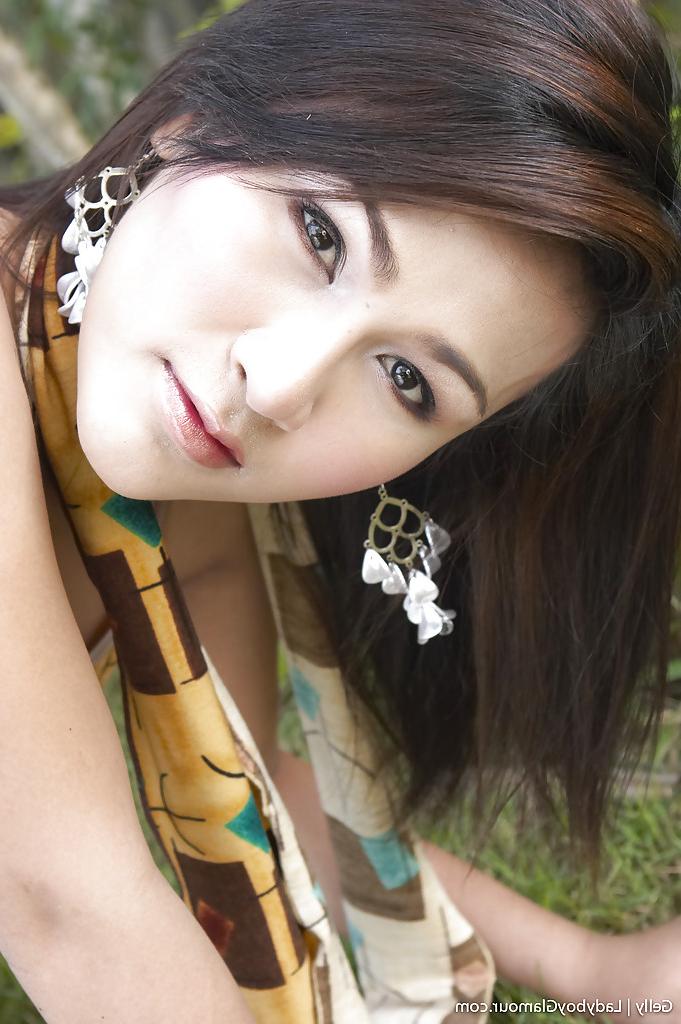 16P Gorgeous Thai ladyboy Gelly and her uncut shecock posing solo outdoors