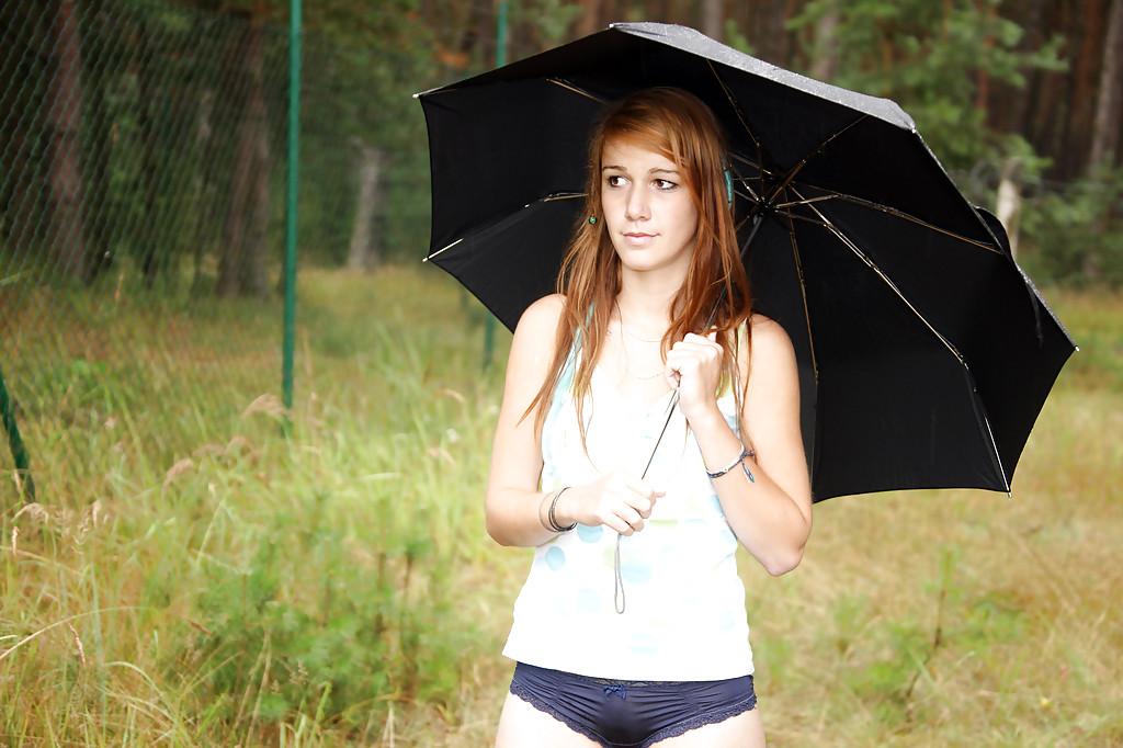 16P Lovely teen Anouk outdoors in the rain rubbing her smooth spread pussy
