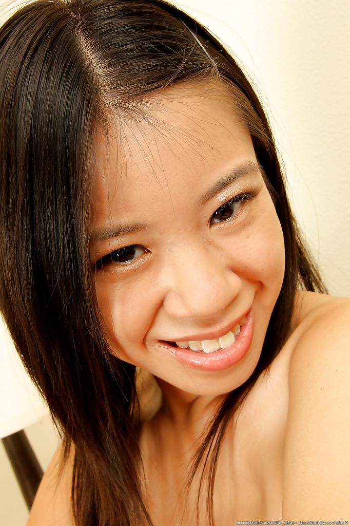 16P Shaved Asian amateur babe Asia Zo taking off her skirt and posing nude