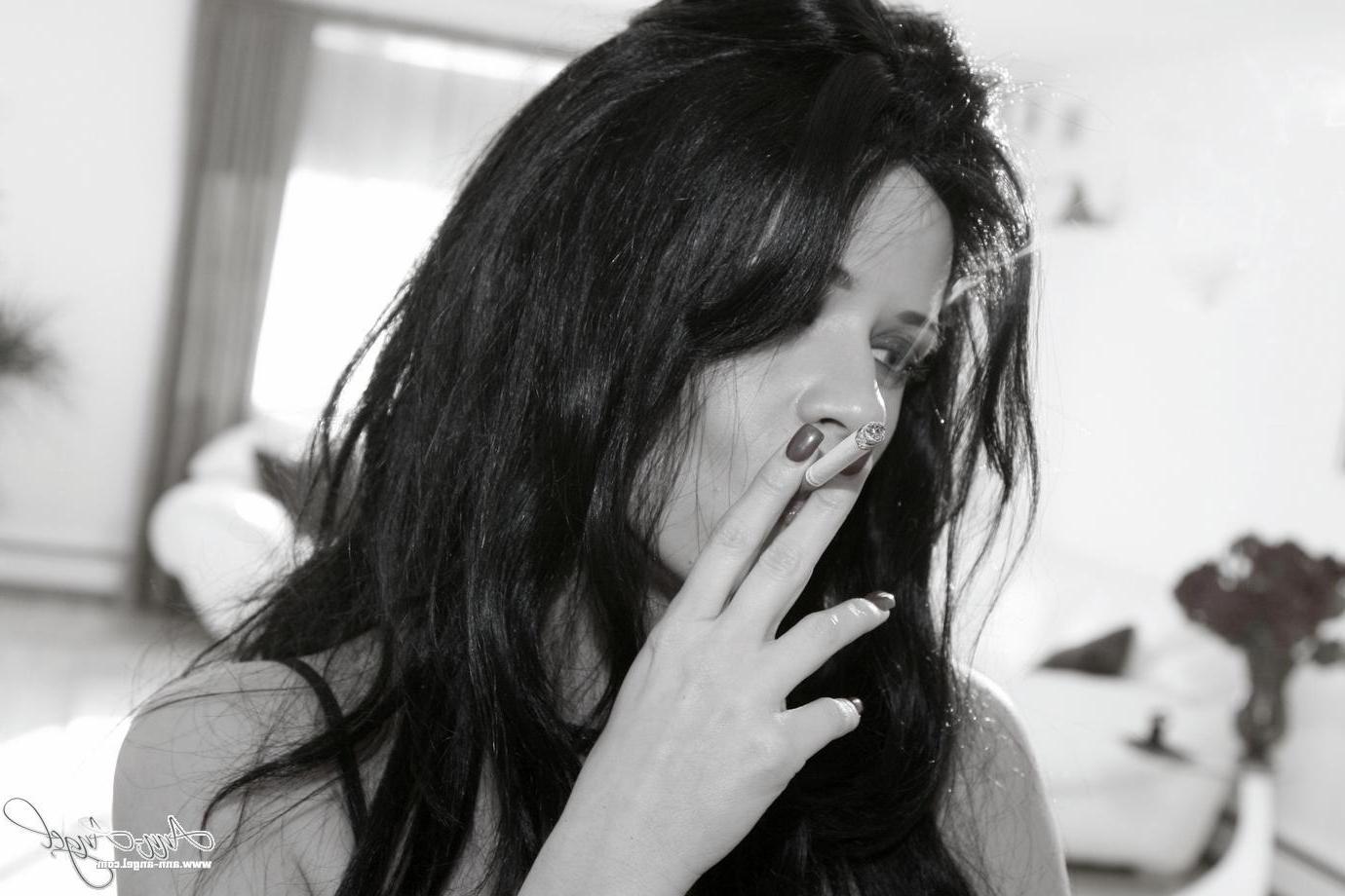 16P Pictures of Ann Angel smoking a cigarette in black lingerie