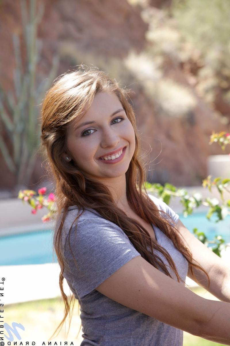 15P Fresh faced brunette Ariana Grand fondles her shaved pussy by the pool