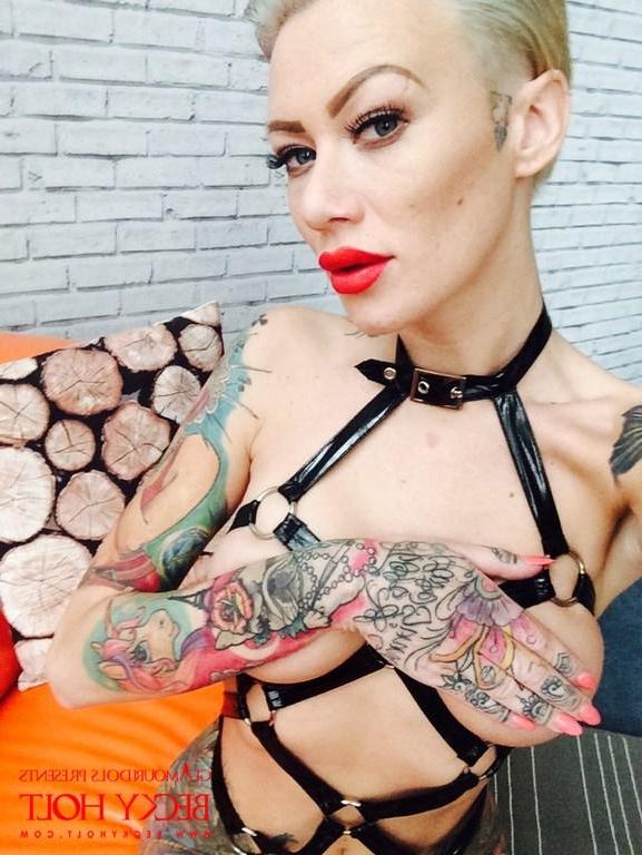 12P Punk babe Becky Holt shows off her tattooed body in leather straps