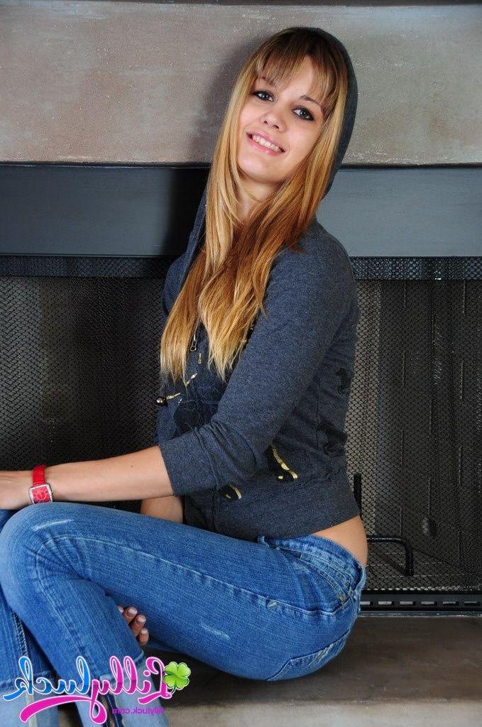 20P Pictures of Lilly Luck getting nude by the fireplace