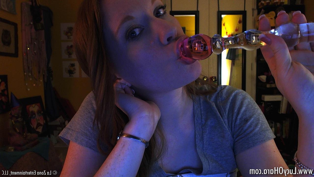 14P Lucy Ohara slips off her black thong and tee to play with her glass dildo and cums hard