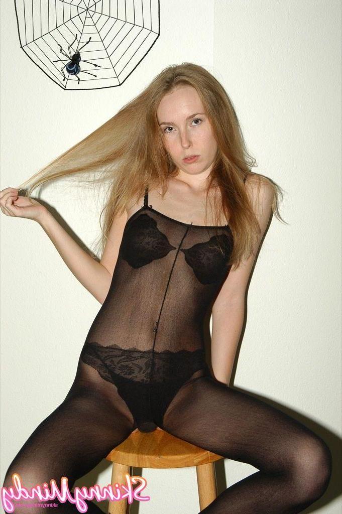 20P Pictures of Skinny Mindy stripping out of a pantyhose suit