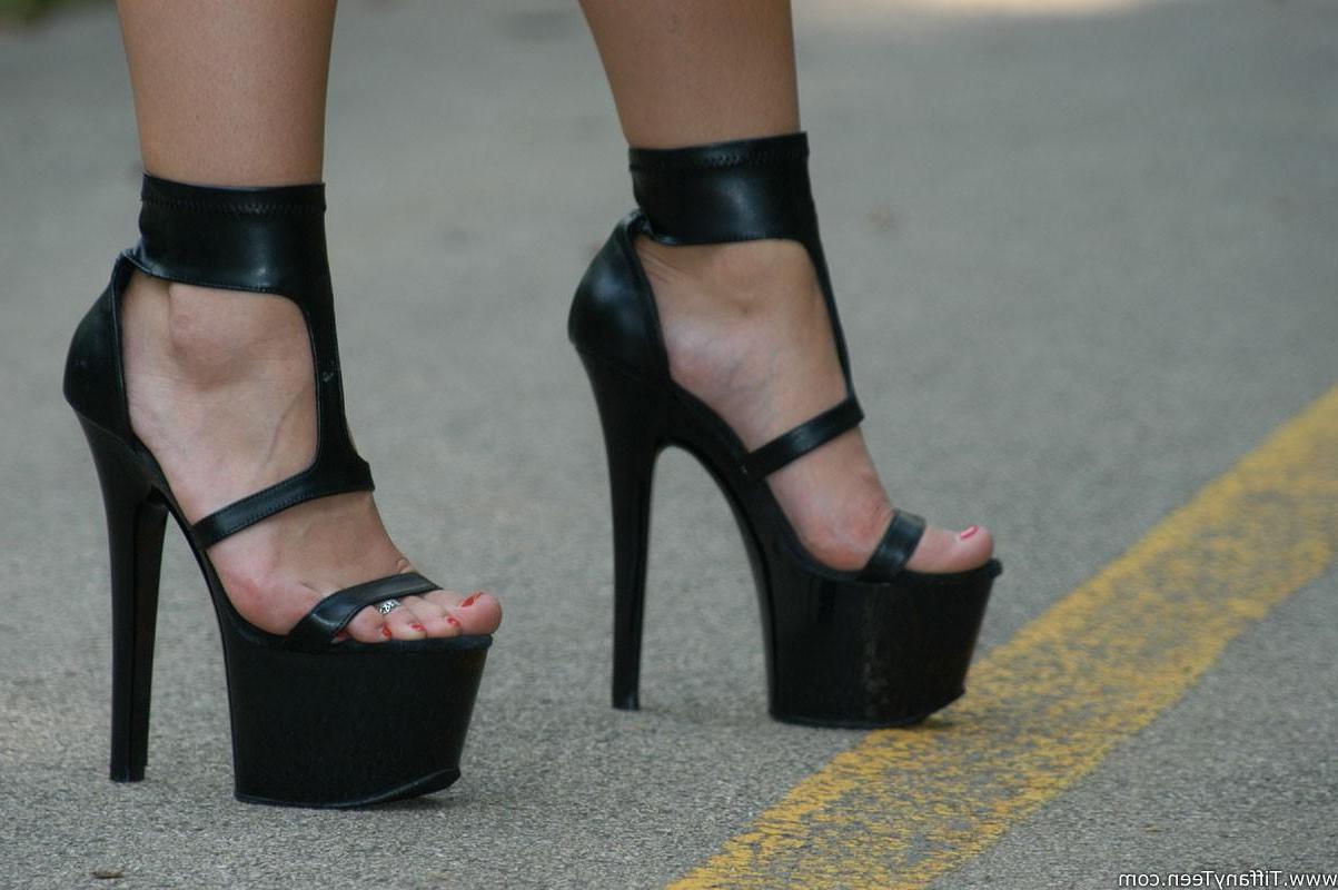 15P Tiffany outside in black heels and a black outfit
