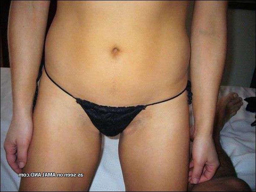 15P Shy Asian chick posing with her ass in a tiny thong