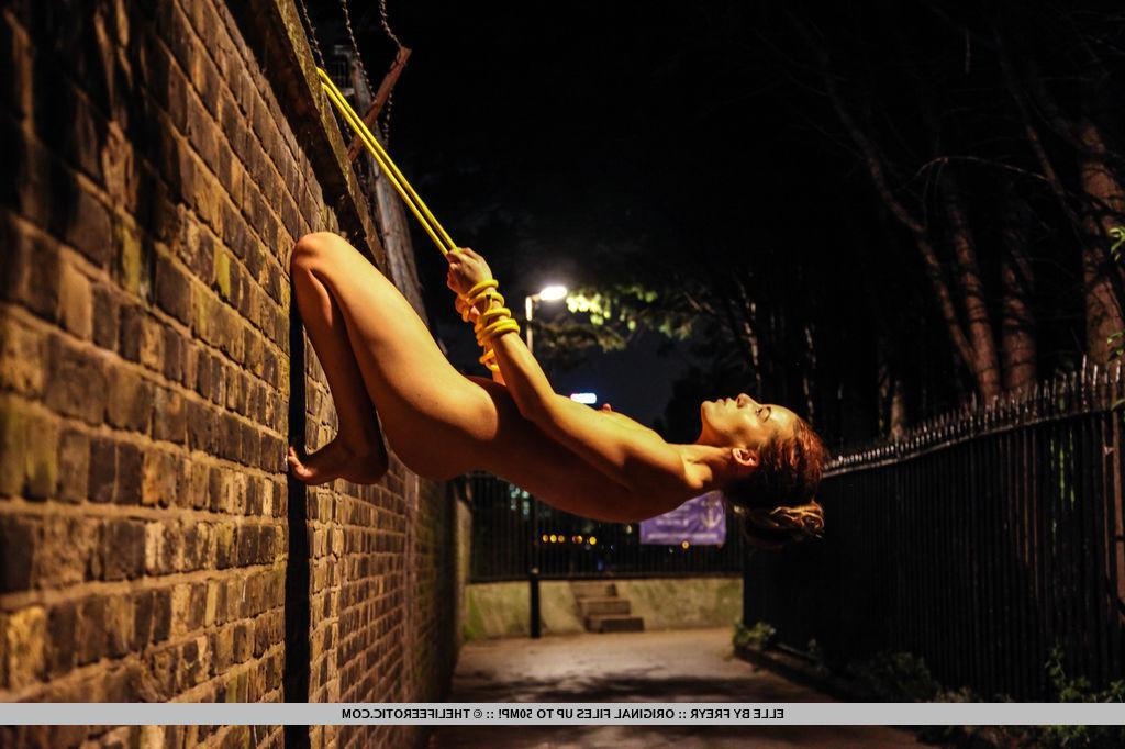16P Brunette girl Elle attempts to scale a wal lin "Nightlife"