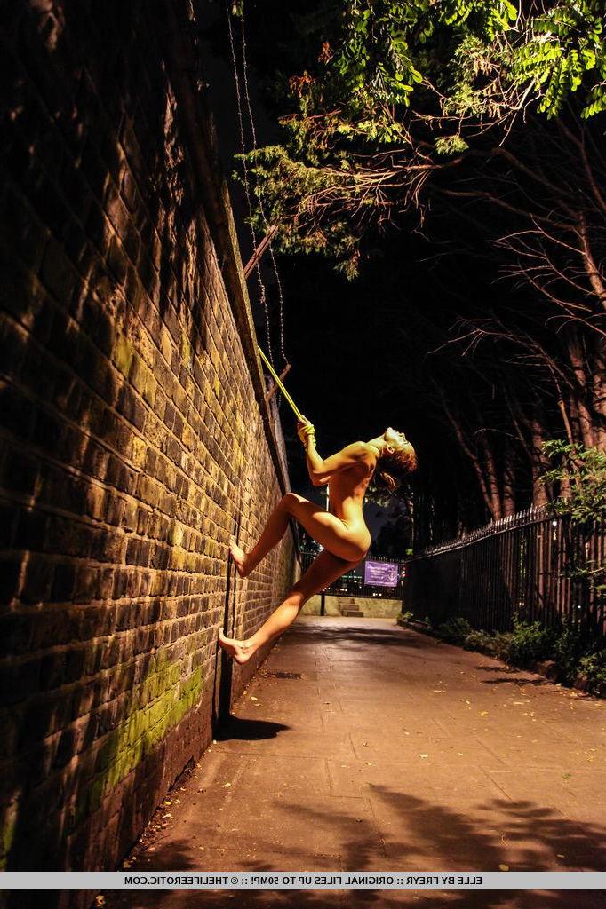 16P Brunette girl Elle attempts to scale a wal lin "Nightlife"