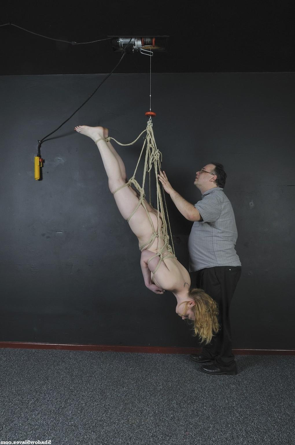 16P Amber West is tied up tightly and then hoisted up to the ceiling