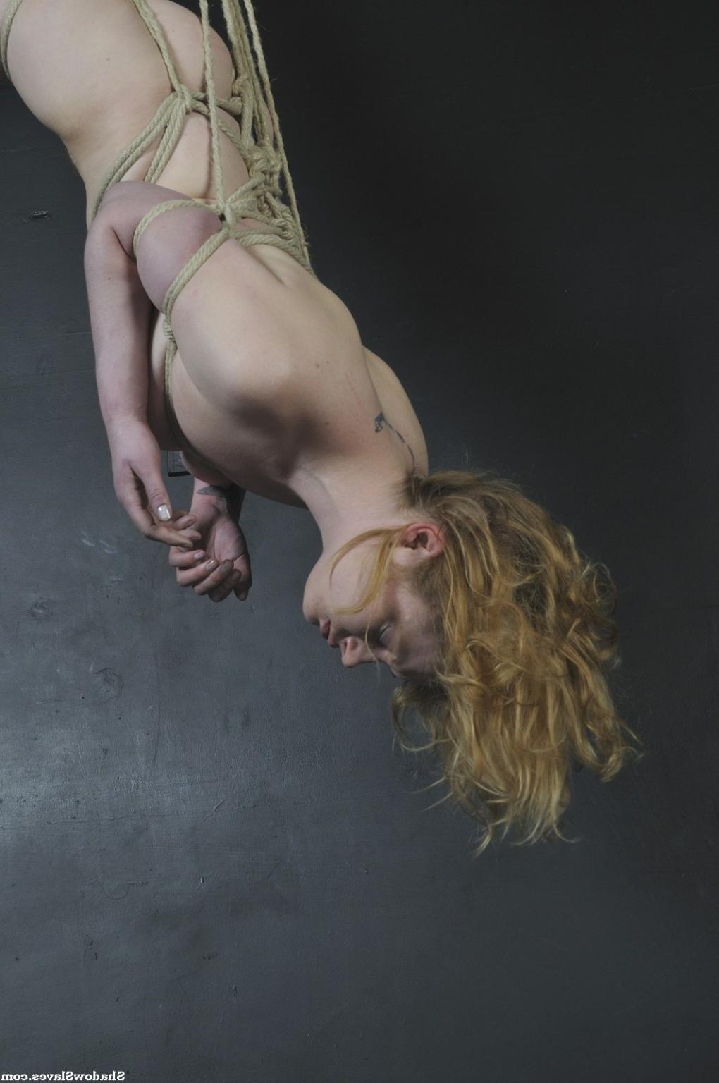 16P Amber West is tied up tightly and then hoisted up to the ceiling