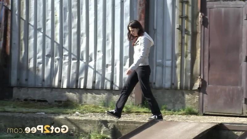 15P Gorgeous brunette filmed twice pissing outside