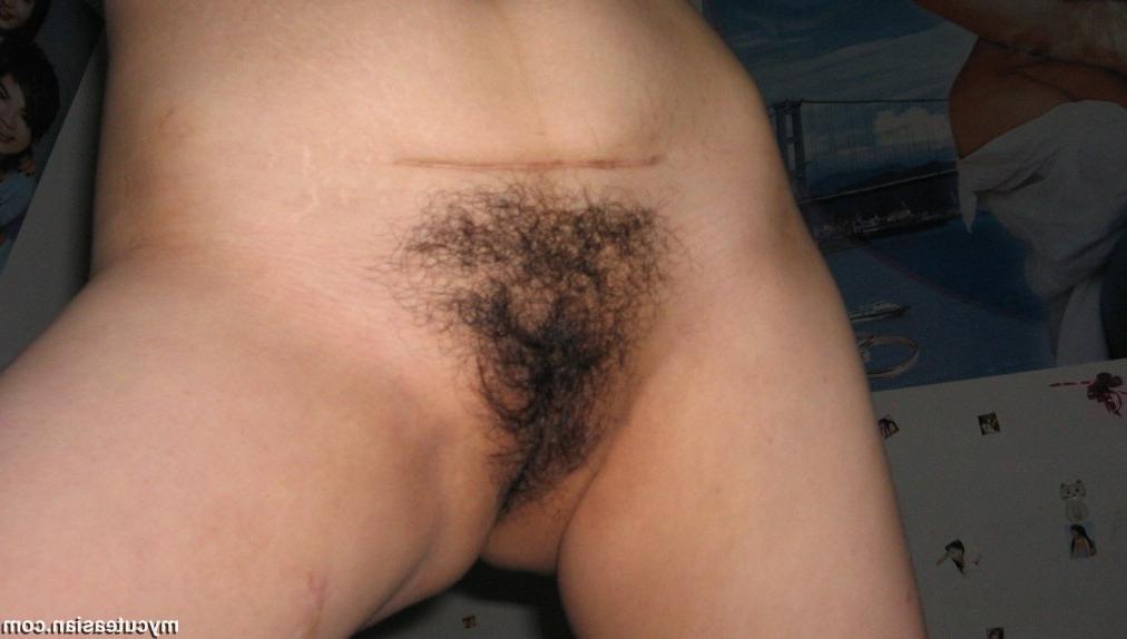 15P Naked Asian amateur shows her hairy pussy
