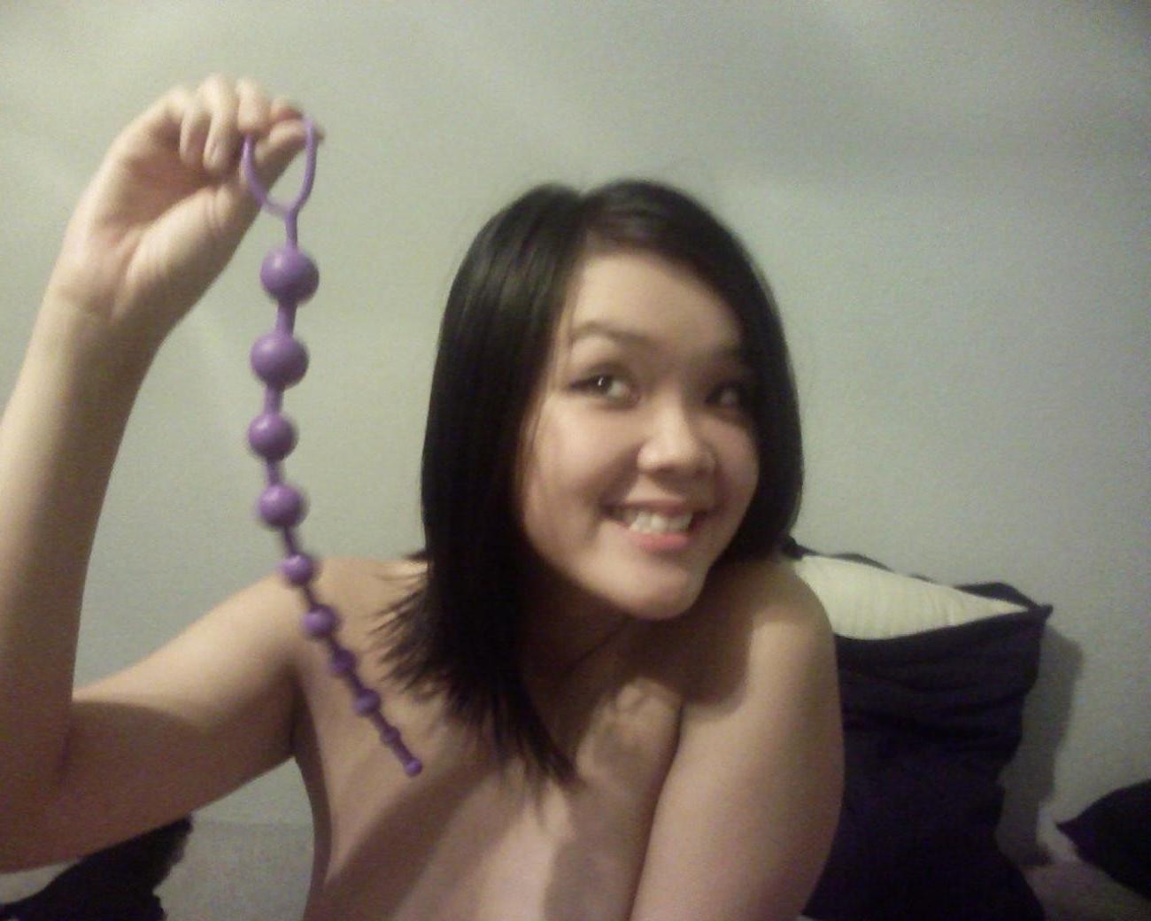 16P Asian does a stiptease befoe sliding her pussy on huge cock
