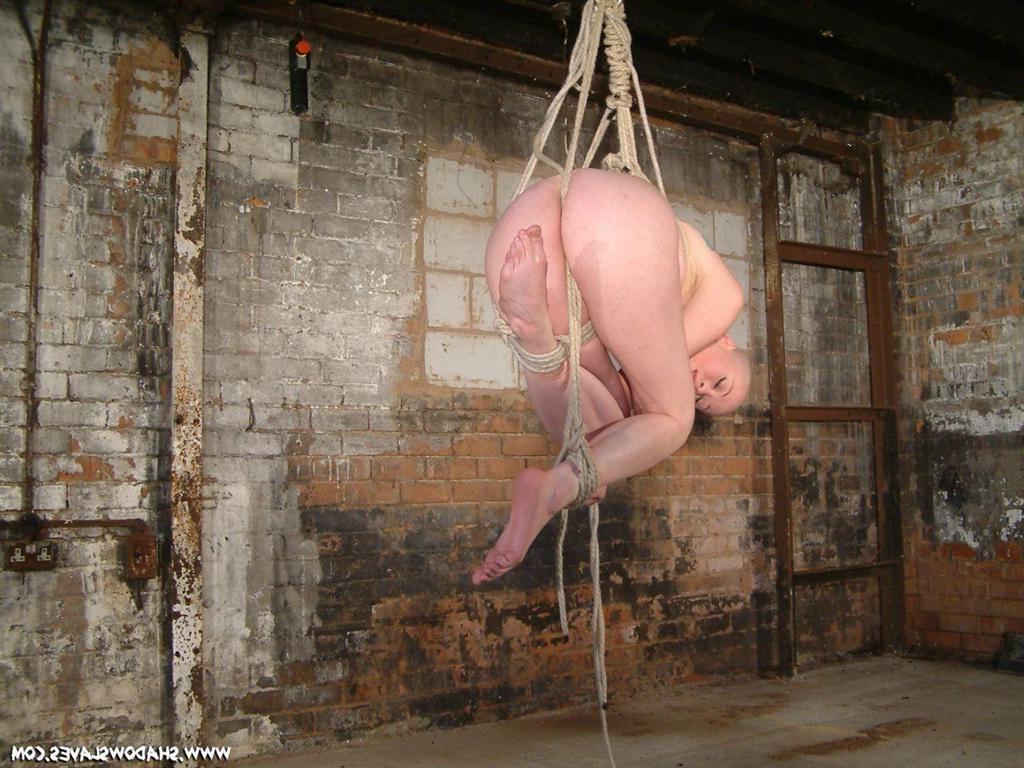 15P Bald asian slavegirl wriggles around in rope suspension bondage
