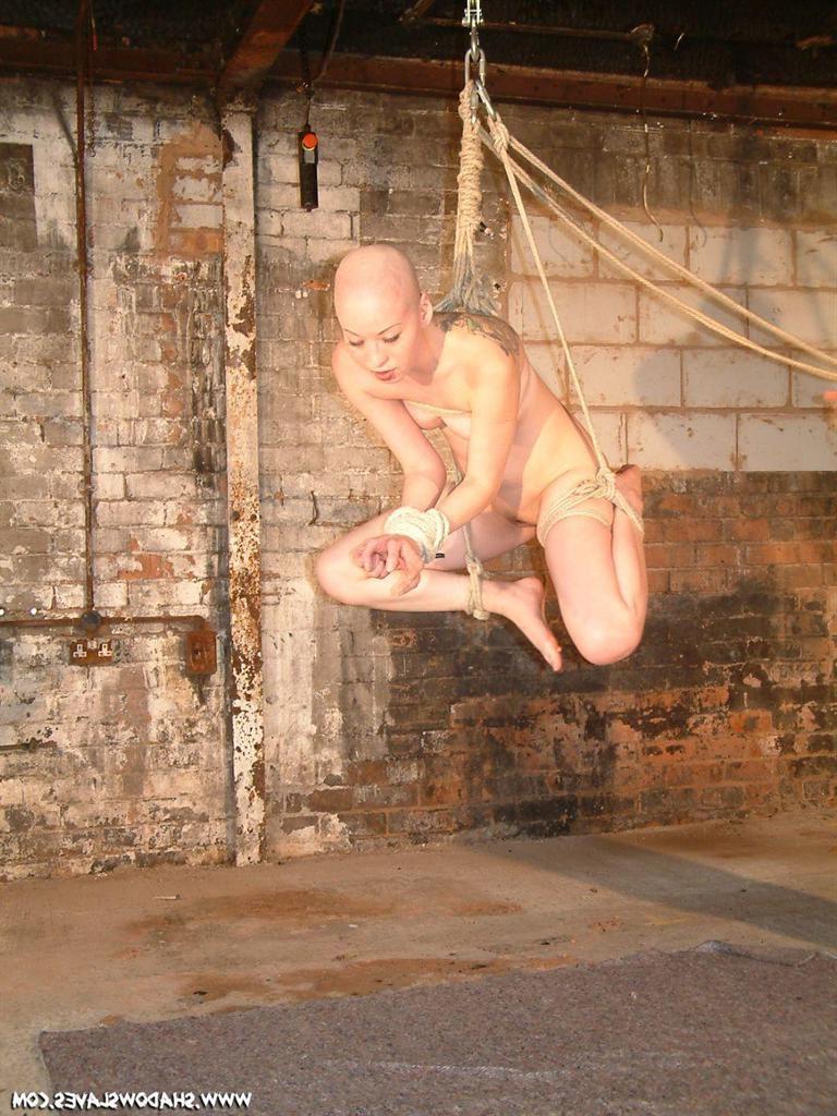 15P Bald asian slavegirl wriggles around in rope suspension bondage