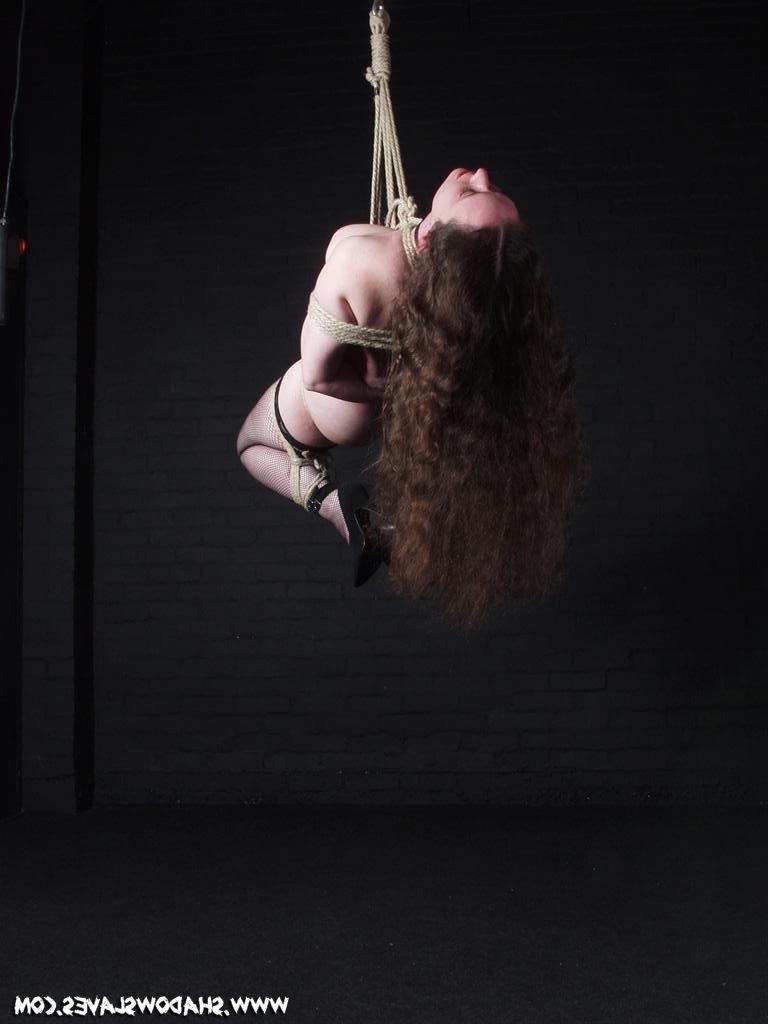 15P Brunette slave in rope suspension bondage ties
