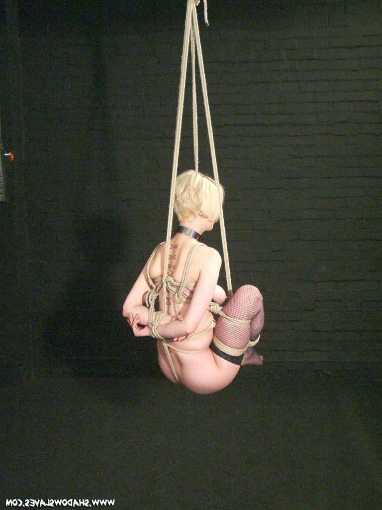 15P Pretty blonde babe suspended in tight rope bondage
