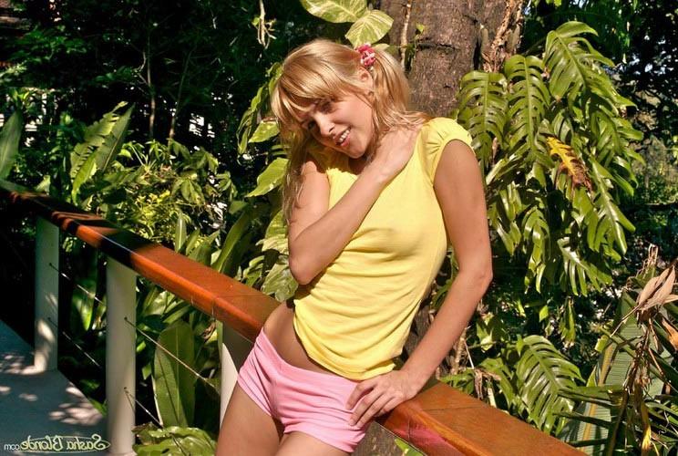 17P Young stunning blonde model showing her unshaved pussy outdoors