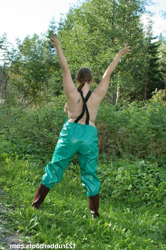 20P Girl with big tits outdoors wearing sexy rubber rainwear.