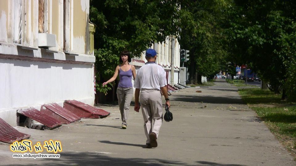 16P Amateur chick standing on a sidewalk and shamelessly pissing her pants