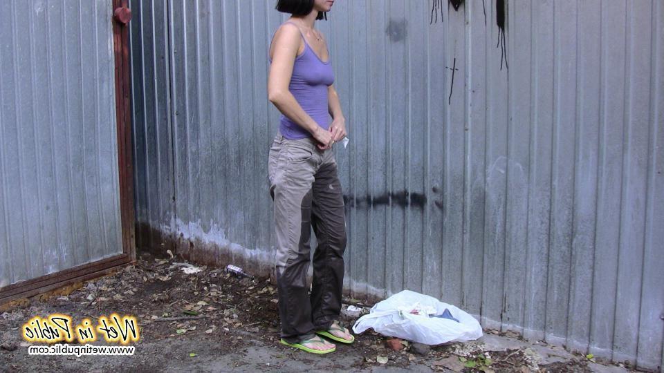 16P Amateur chick standing on a sidewalk and shamelessly pissing her pants