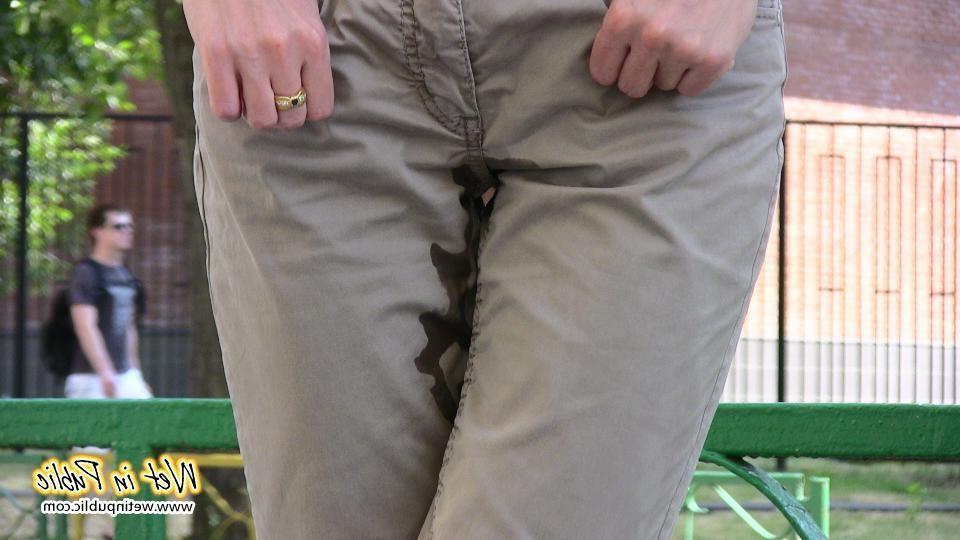 16P Amateur chick standing on a sidewalk and shamelessly pissing her pants