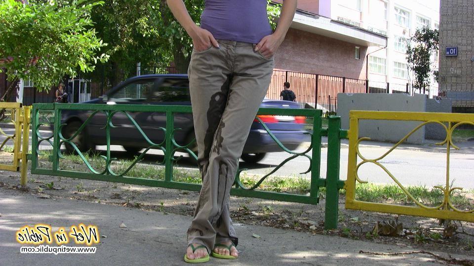 16P Amateur chick standing on a sidewalk and shamelessly pissing her pants
