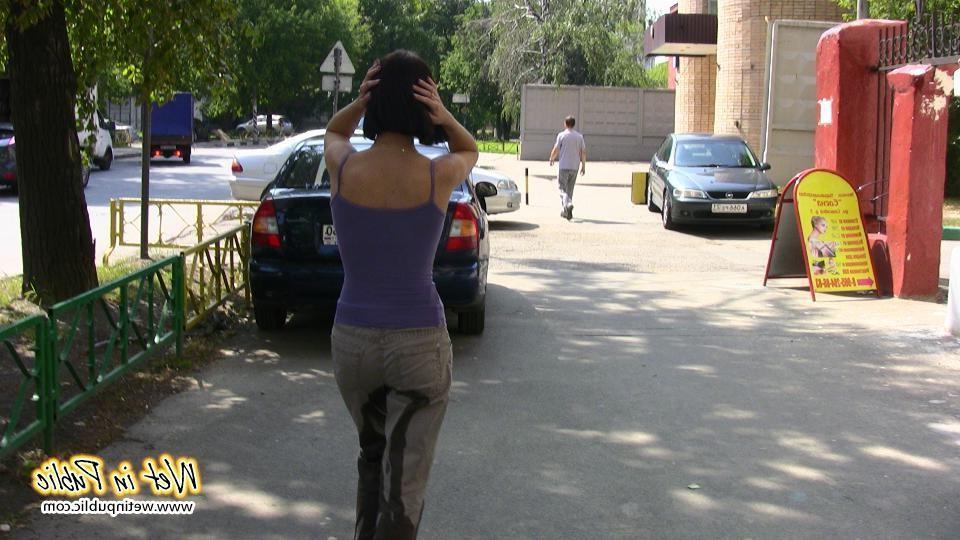 16P Amateur chick standing on a sidewalk and shamelessly pissing her pants
