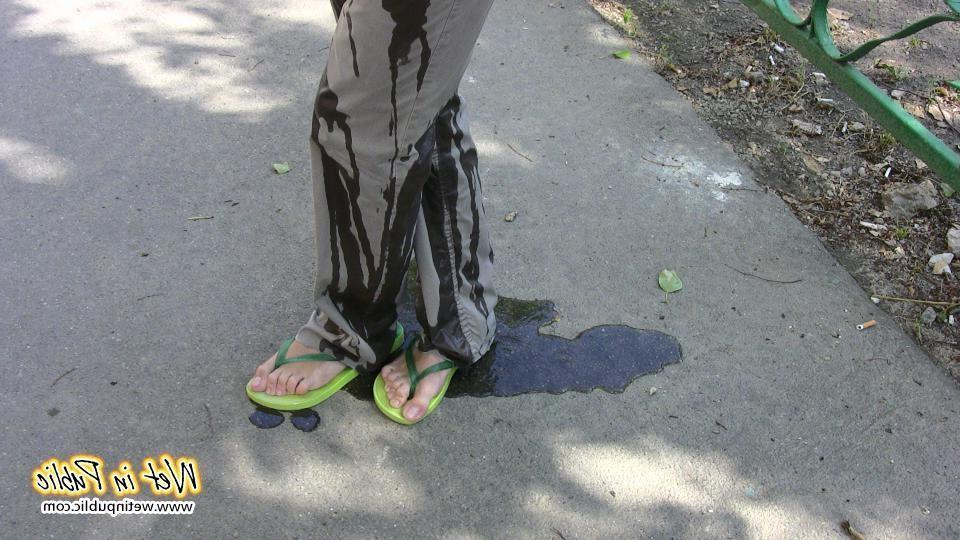 16P Amateur chick standing on a sidewalk and shamelessly pissing her pants