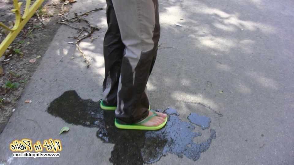 16P Amateur chick standing on a sidewalk and shamelessly pissing her pants