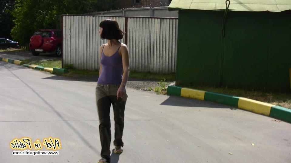 16P Amateur chick standing on a sidewalk and shamelessly pissing her pants