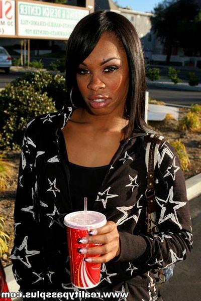 16P ebony hottie sits on the bed to suck off a black reality dick