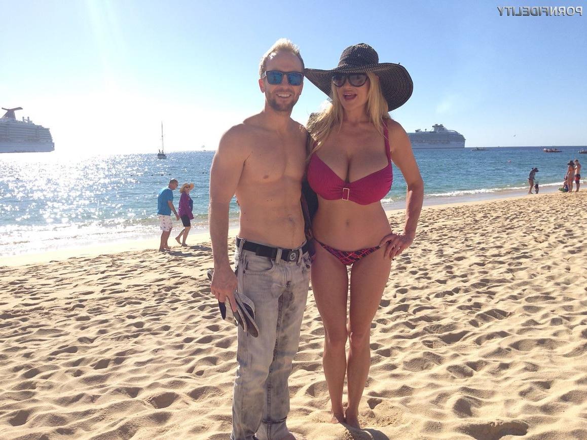 16P Kelly Madison shows off her big tits during a beach vacation