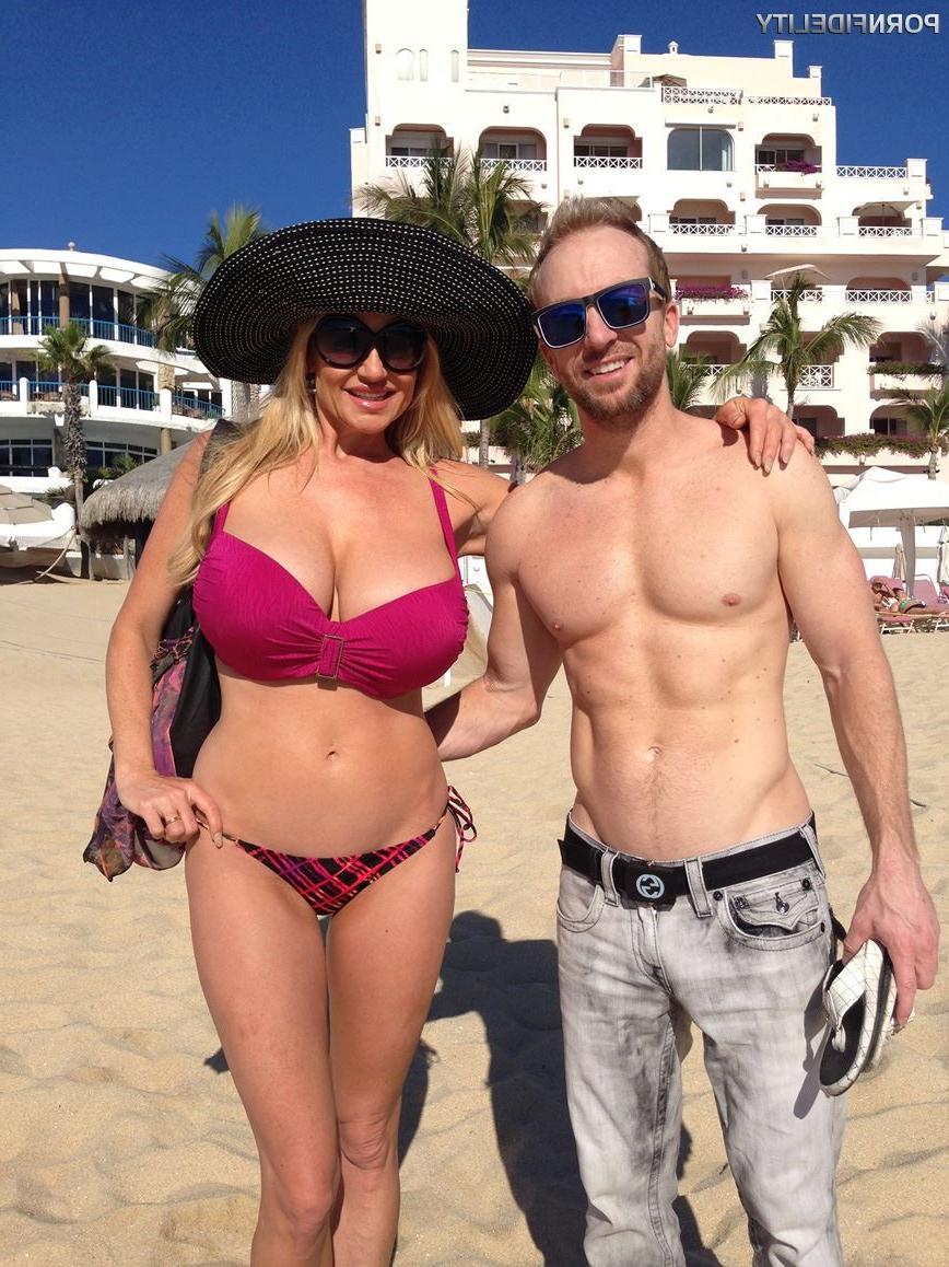 16P Kelly Madison shows off her big tits during a beach vacation