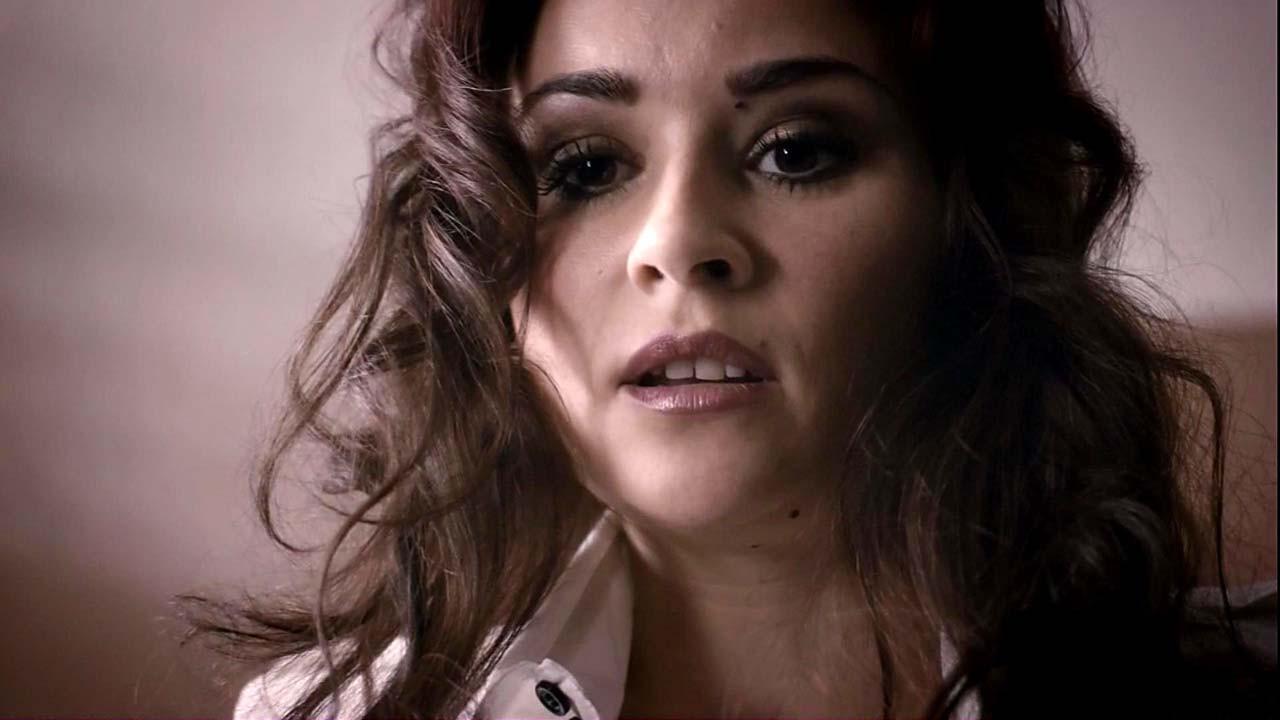 9P Emma Pierson showing her nice big boobs and in black lingerie posing in movie sc