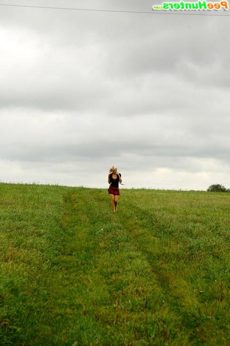 16P Gorgeous busty blonde filmed pissing on a field