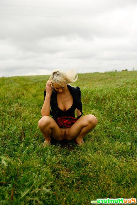 16P Gorgeous busty blonde filmed pissing on a field