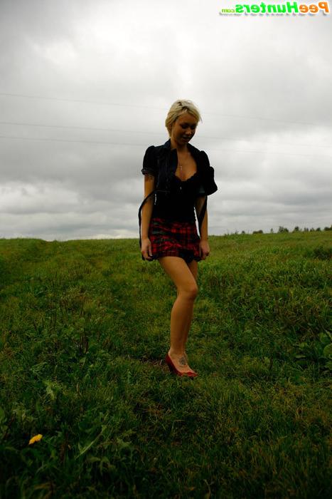 16P Gorgeous busty blonde filmed pissing on a field
