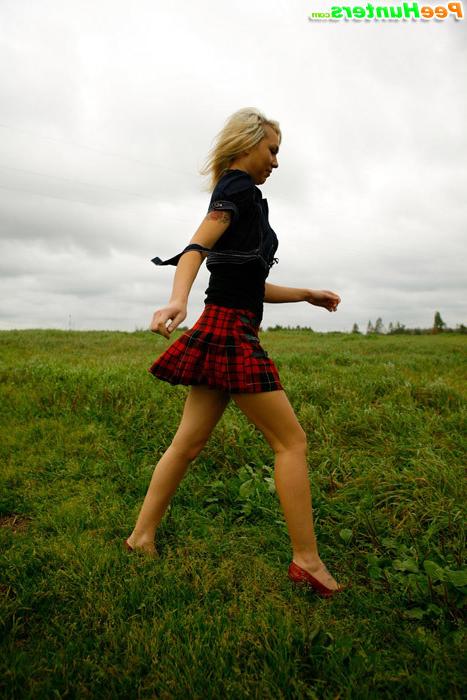 16P Gorgeous busty blonde filmed pissing on a field