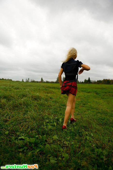 16P Gorgeous busty blonde filmed pissing on a field