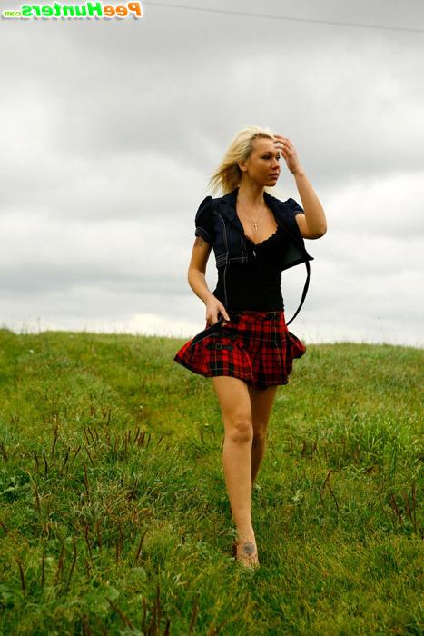 16P Gorgeous busty blonde filmed pissing on a field