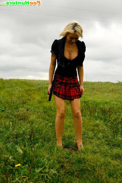 16P Gorgeous busty blonde filmed pissing on a field