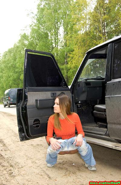 15P Handsome girl peeing near her car after long trip