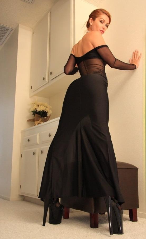 10P Girl posing in long black dress and platform heels